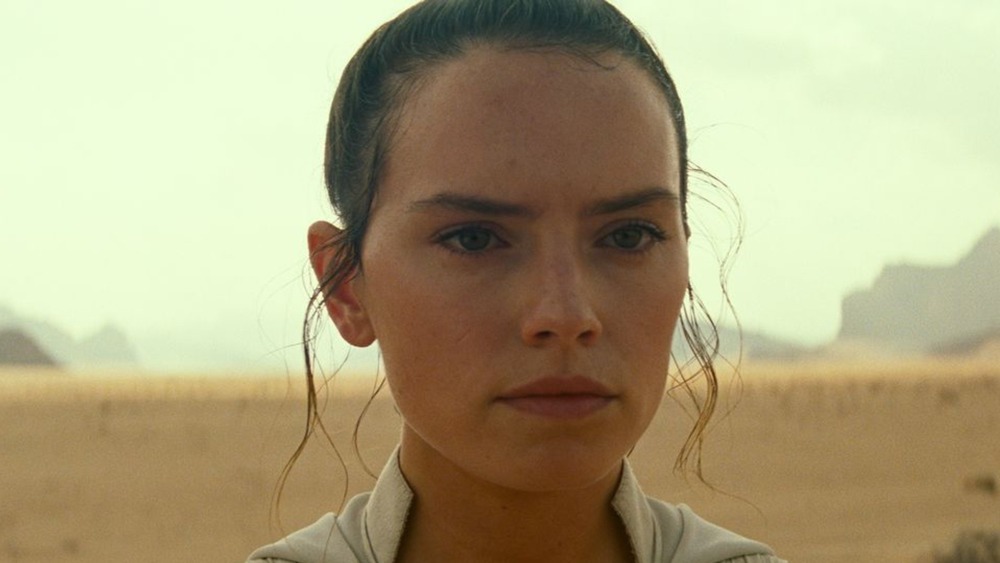 Rey stares off in the distance