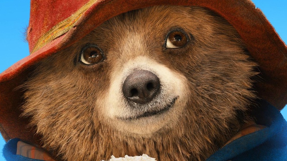 Paddington Bear holding a sandwich