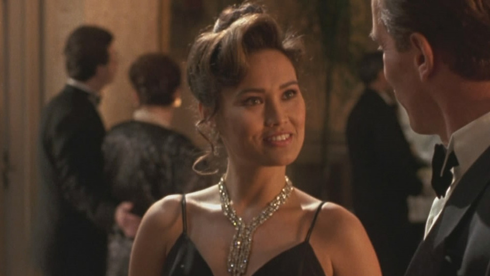 Tia Carrere as Juno Skinner in a black dress in True Lies