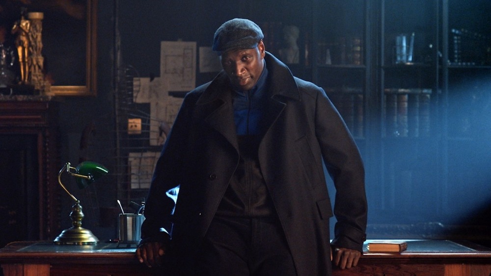 Assane Diop leans on a desk
