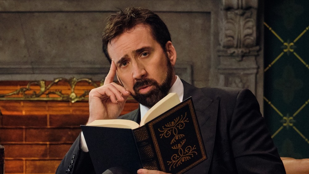 Nicolas Cage touching his temple