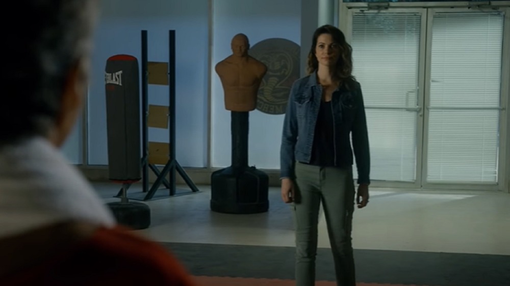 Amanda LaRusso confronting John Kreese at the dojo in the Cobra Kai season 3 trailer