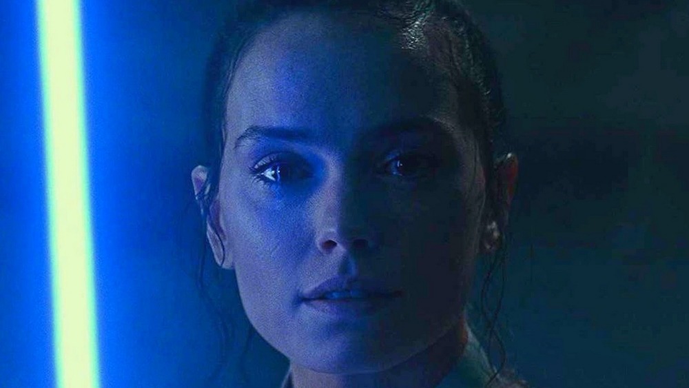Rey with lightsaber