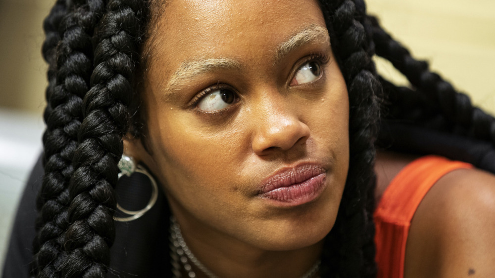Ajani Russell looking annoyed in a scene from Betty