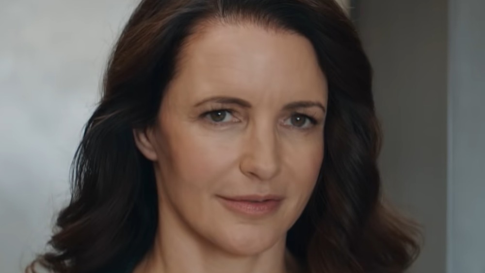 Woman whispering into Mary's ear