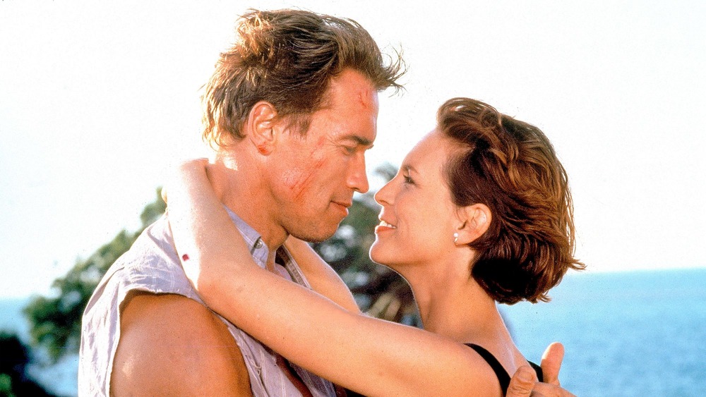 Arnold Schwarzenegger and Jamie Lee Curtis embracing